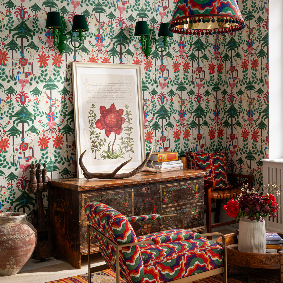 A Woodland Tale Cream wallpaper by MINDTHEGAP, shown in a furnished interior.