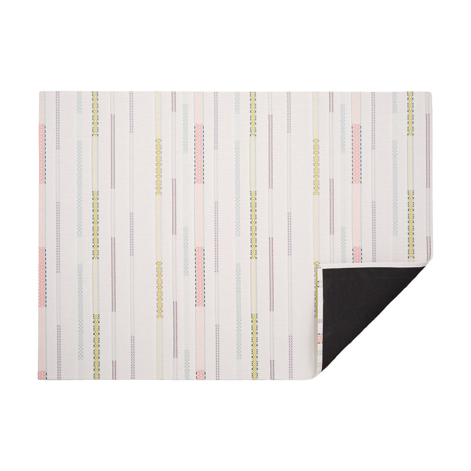 Almond Appliqué woven floor mat by Chilewich, horizontal folded-corner view