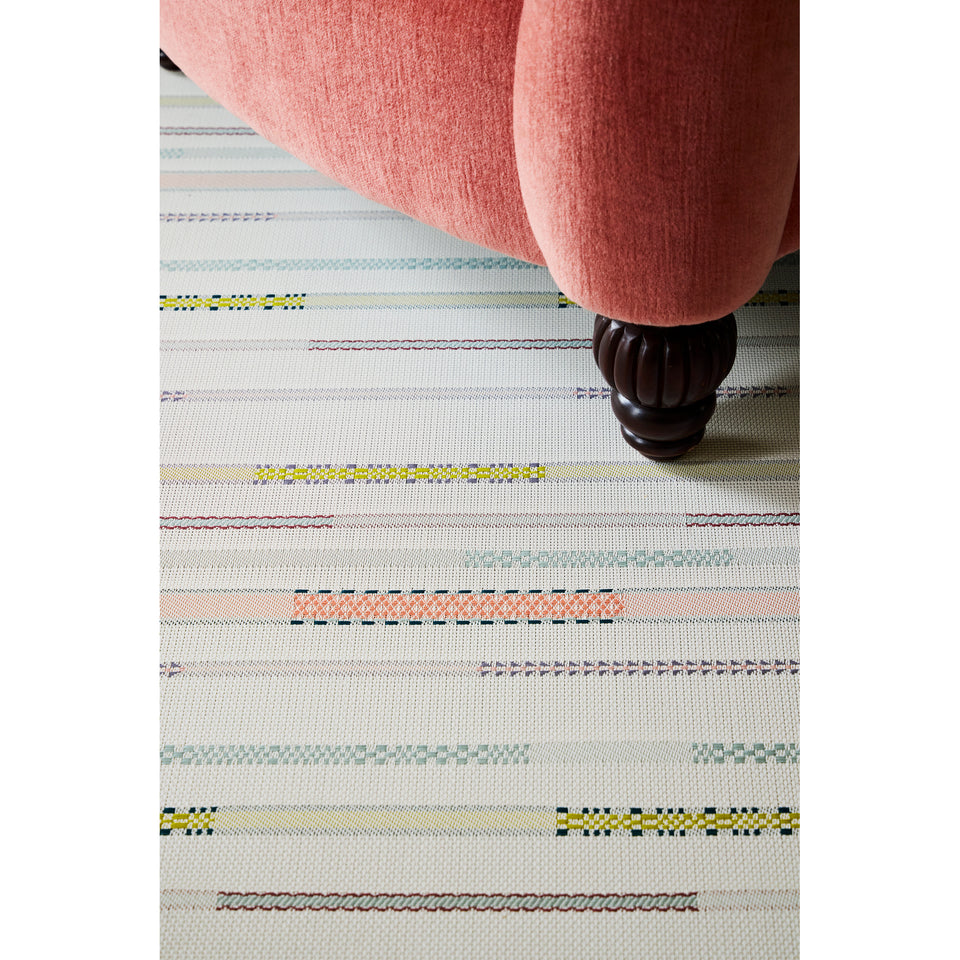 Chilewich Appliqué woven floor mat in Almond in an interior setting