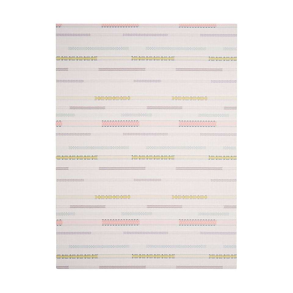 Almond Appliqué woven floor mat by Chilewich, rectangular studio view