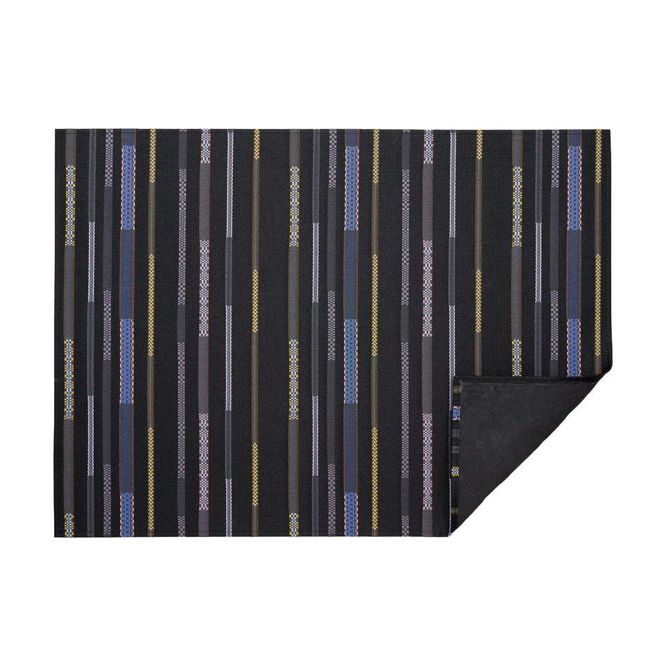 Nero Appliqué woven floor mat by Chilewich, horizontal folded-corner view