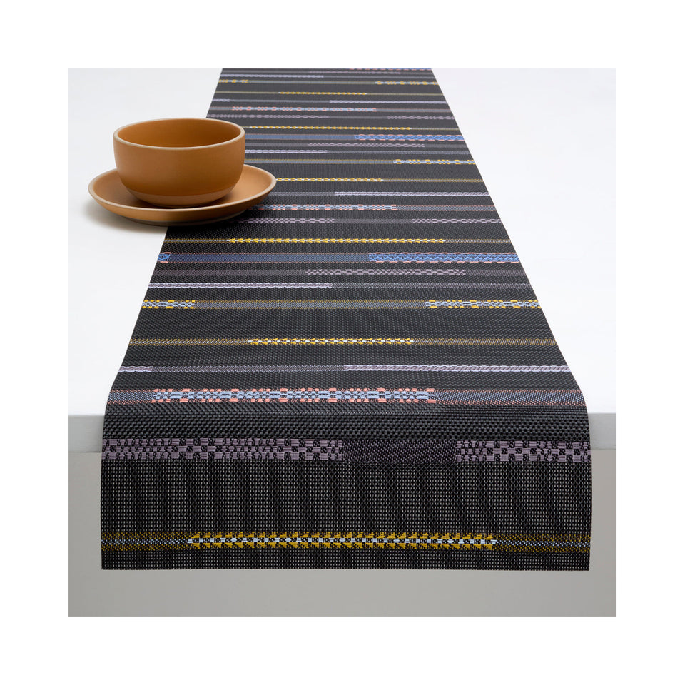 Chilewich Appliqué table runner in Nero, draped across a table
