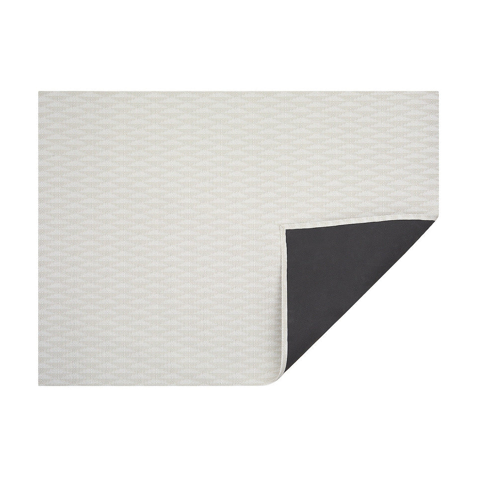 Porcelain Arrow woven floor mat by Chilewich, horizontal folded-corner view