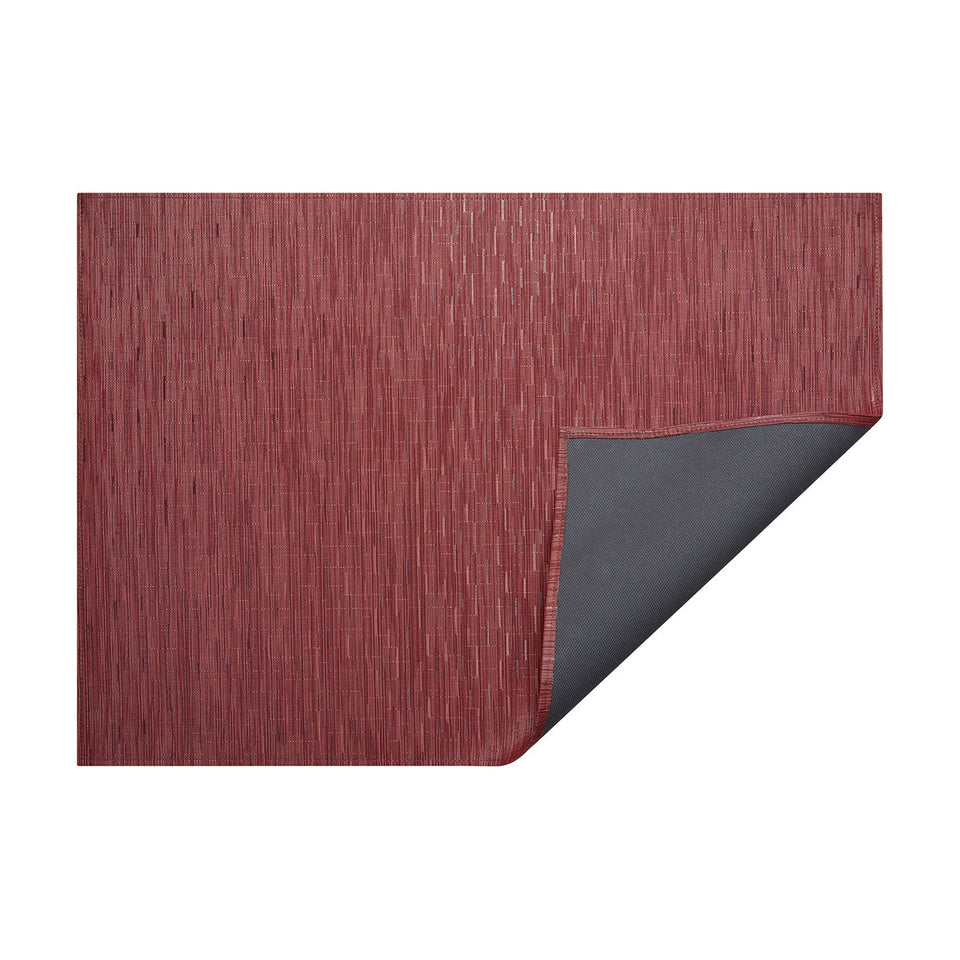 Cranberry Bamboo woven floor mat by Chilewich, horizontal folded-corner view