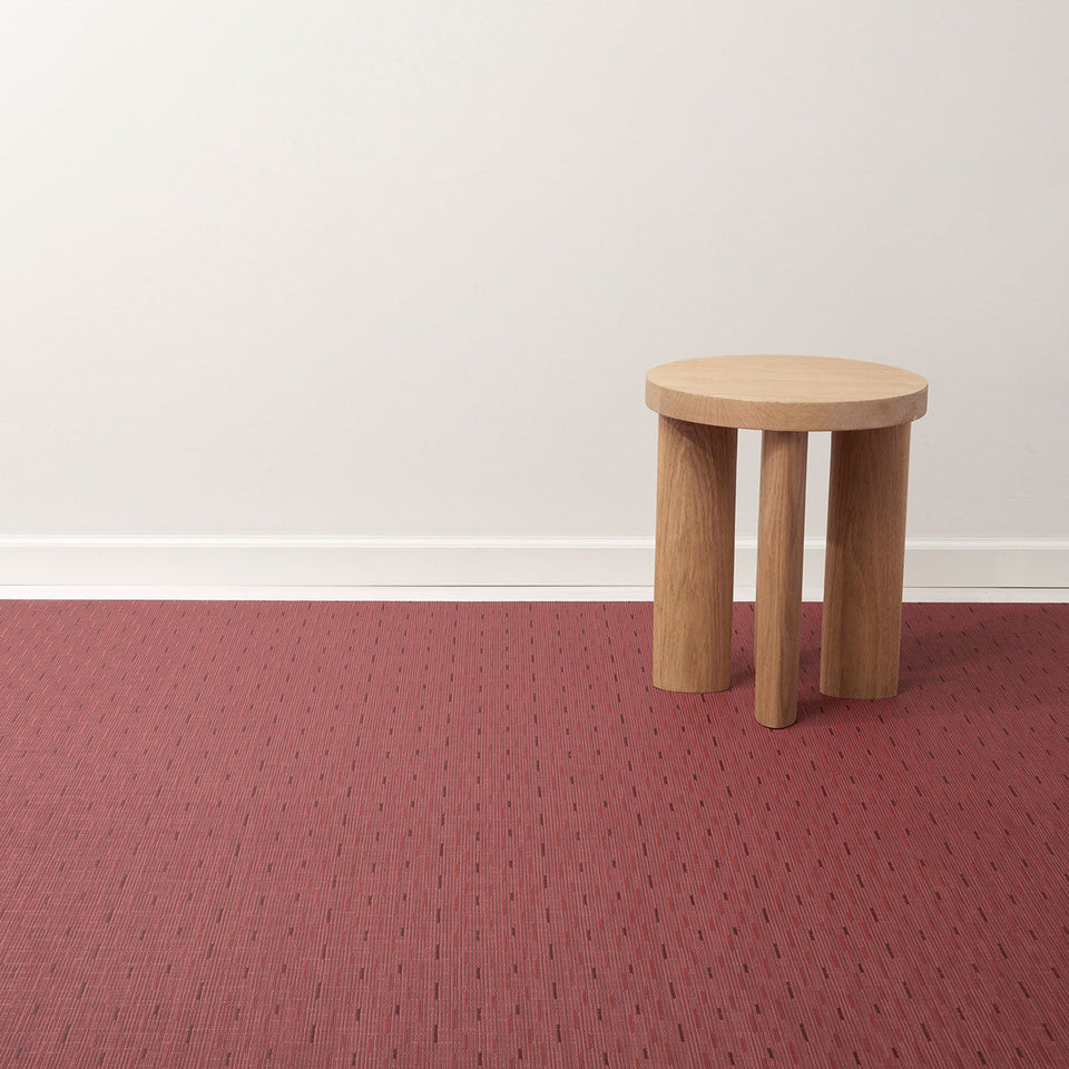 Bamboo / Cranberry woven floor mat by Chilewich, interior setting