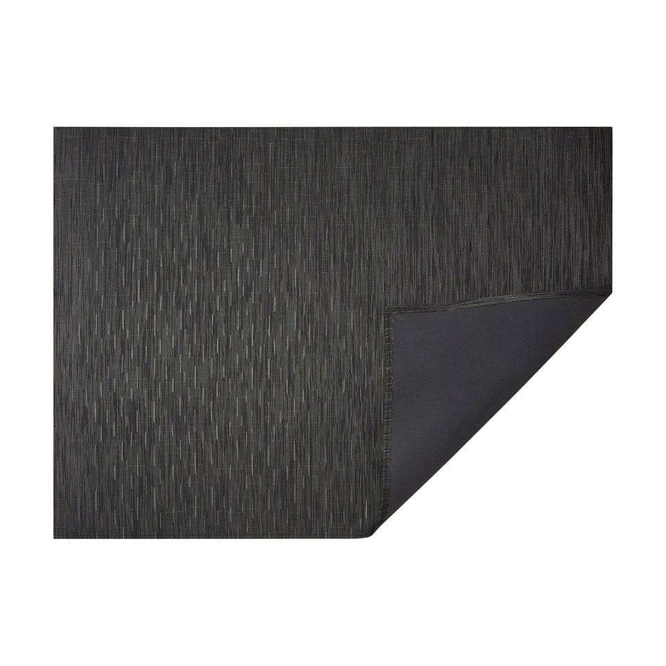 Smoke Bamboo woven floor mat by Chilewich, horizontal folded-corner view