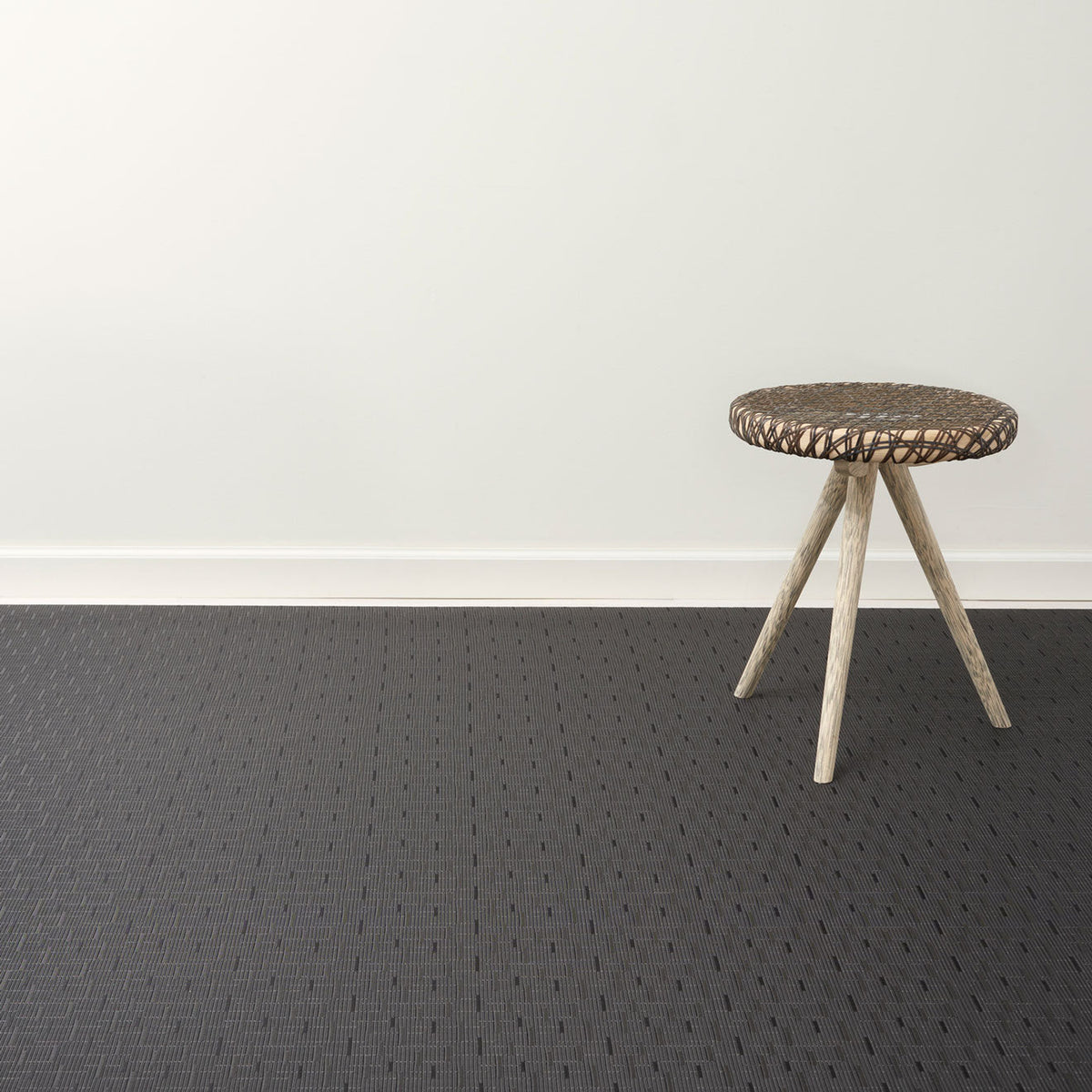 Bamboo / Smoke woven floor mat by Chilewich, interior setting