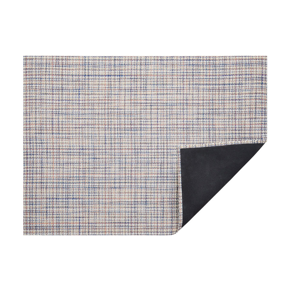 Bon Bon Basketweave woven floor mat by Chilewich, horizontal folded-corner view