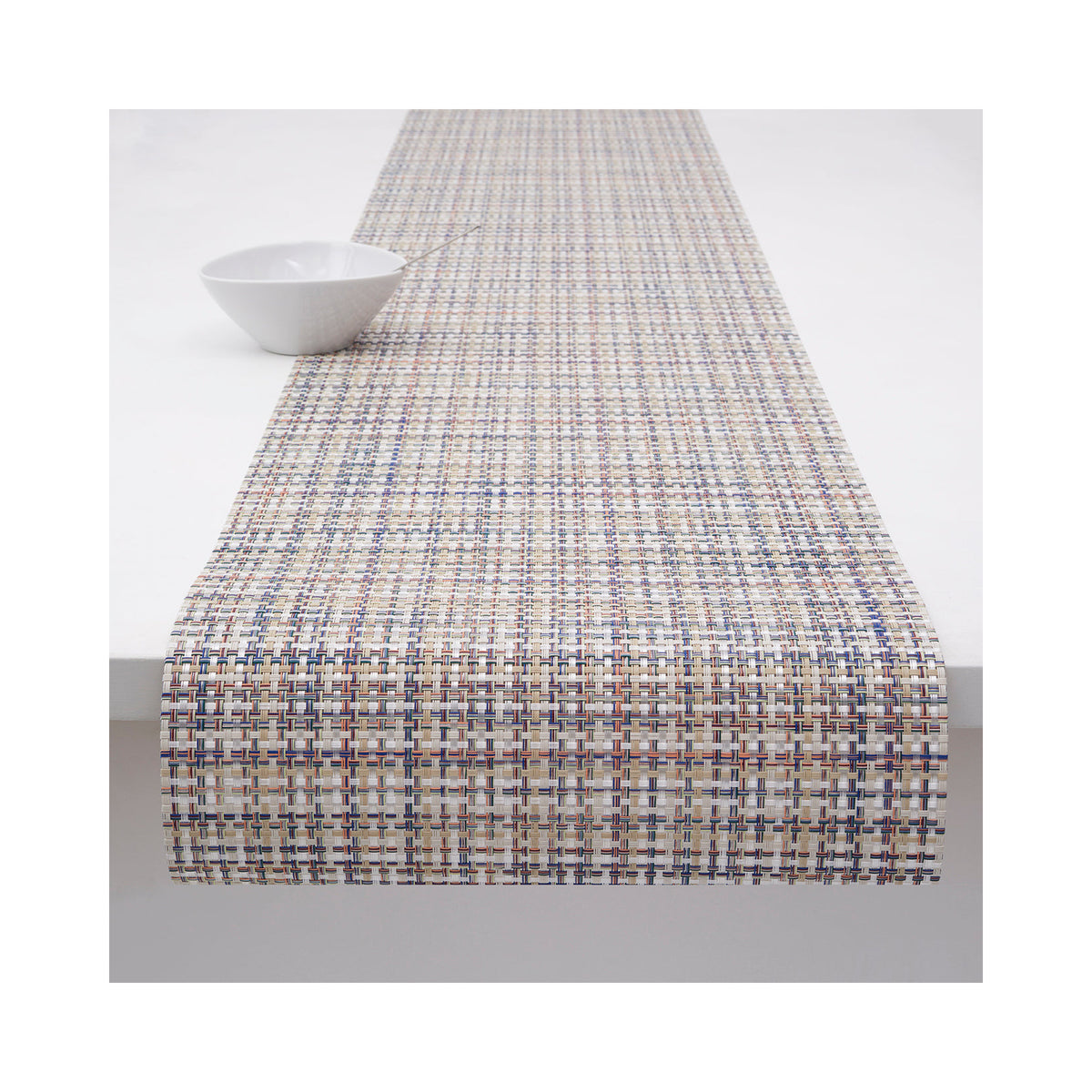 Chilewich Basketweave table runner in Bon Bon, draped across a table