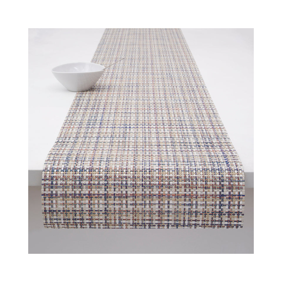 Chilewich Basketweave table runner in Bon Bon, draped across a table