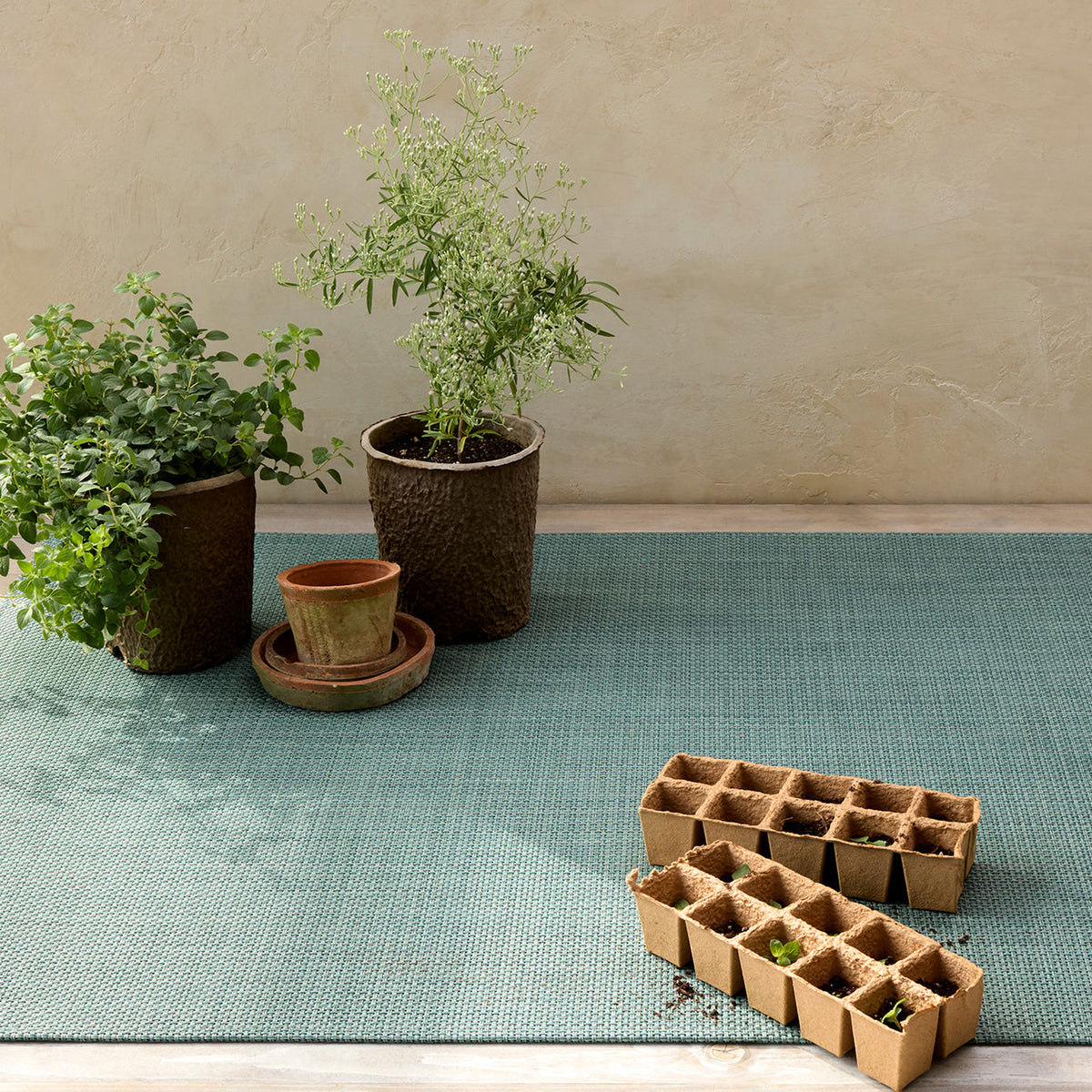 Basketweave / Celadon woven floor mat by Chilewich, interior setting