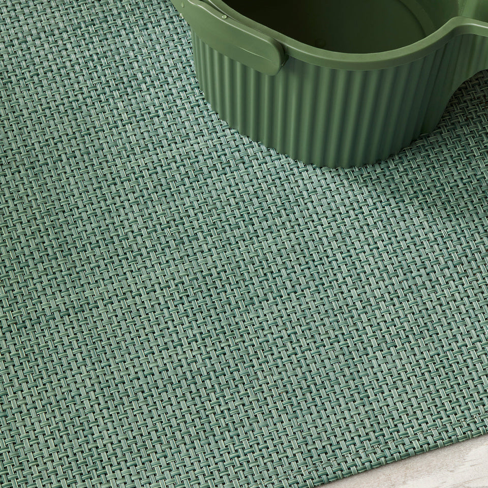 Basketweave / Celadon woven floor mat by Chilewich, interior setting