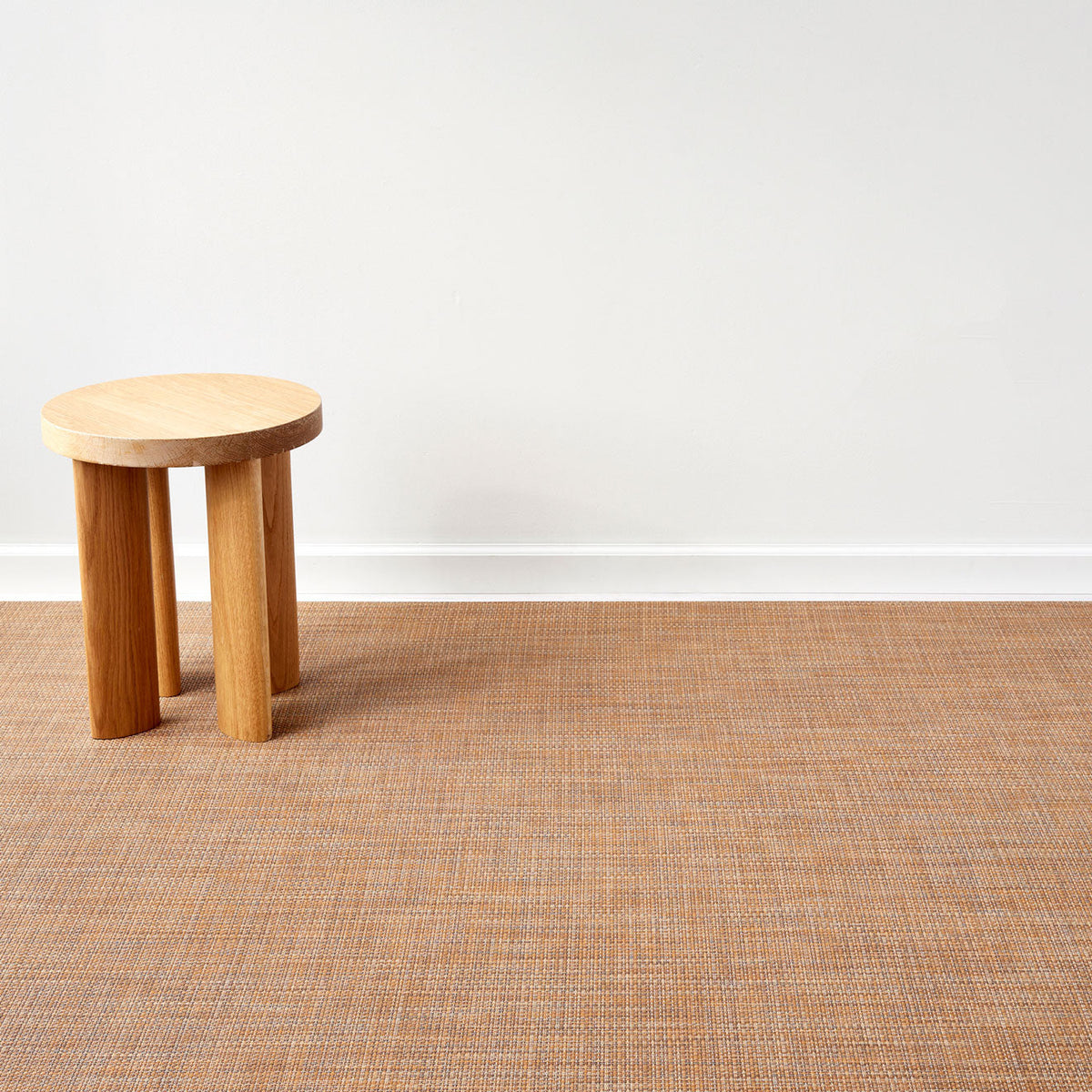 Basketweave / Teak woven floor mat by Chilewich, interior setting