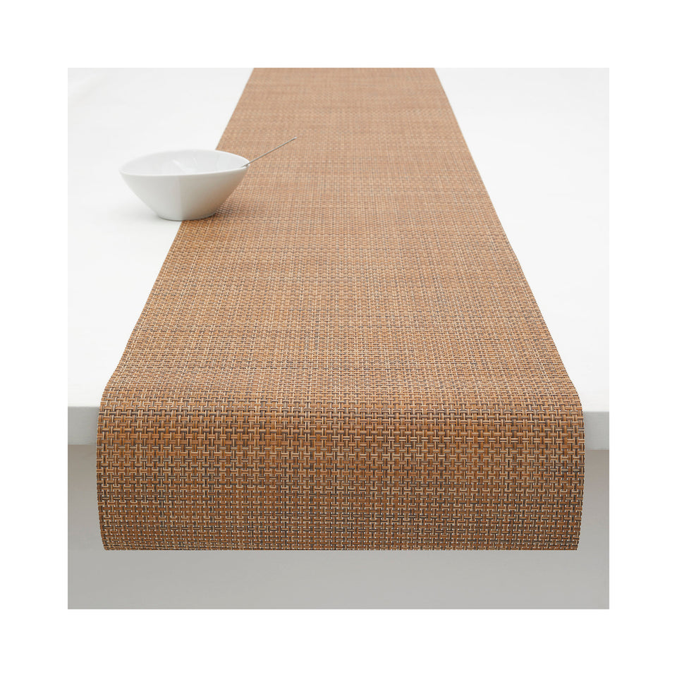 Chilewich Basketweave table runner in Teak, draped across a table