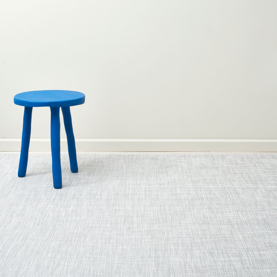 Basketweave / White/Silver woven floor mat by Chilewich, interior setting