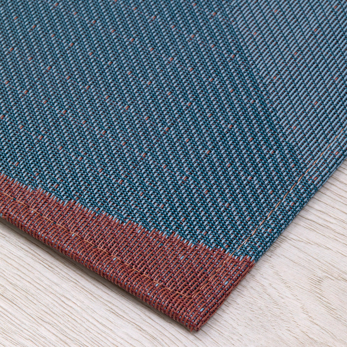 Canopy / Raspberry woven floor mat by Chilewich, interior setting
