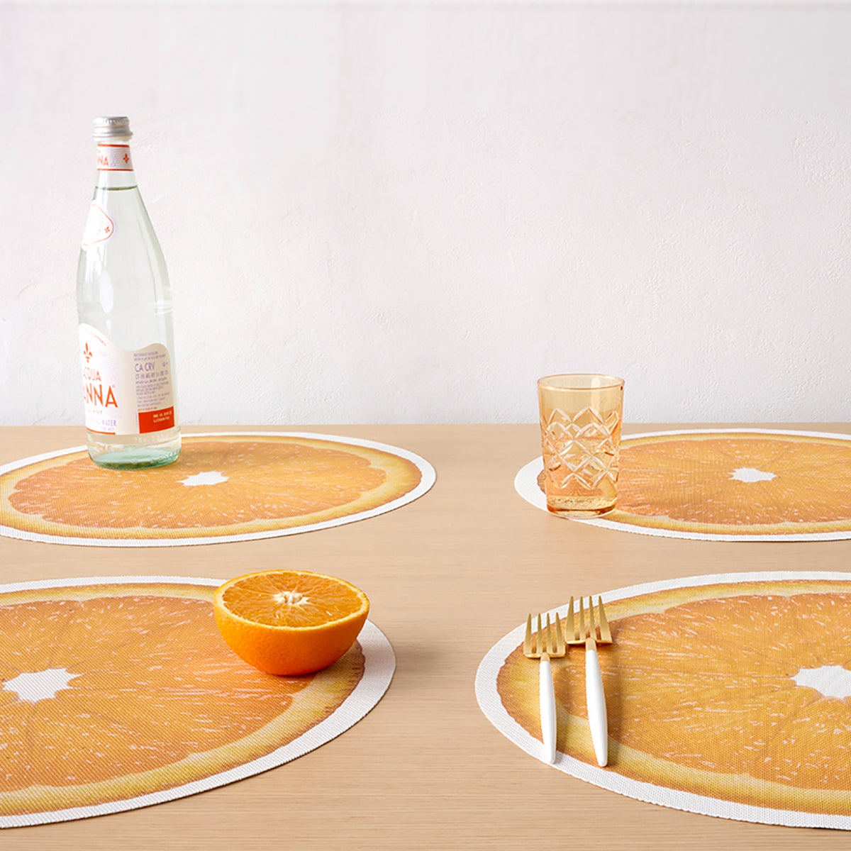 Chilewich Citrus in Orange, shown in a styled table setting