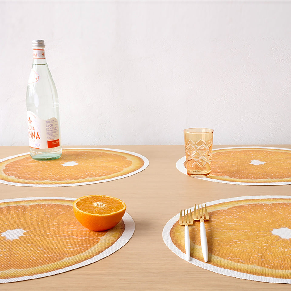 Chilewich Citrus in Orange, shown in a styled table setting