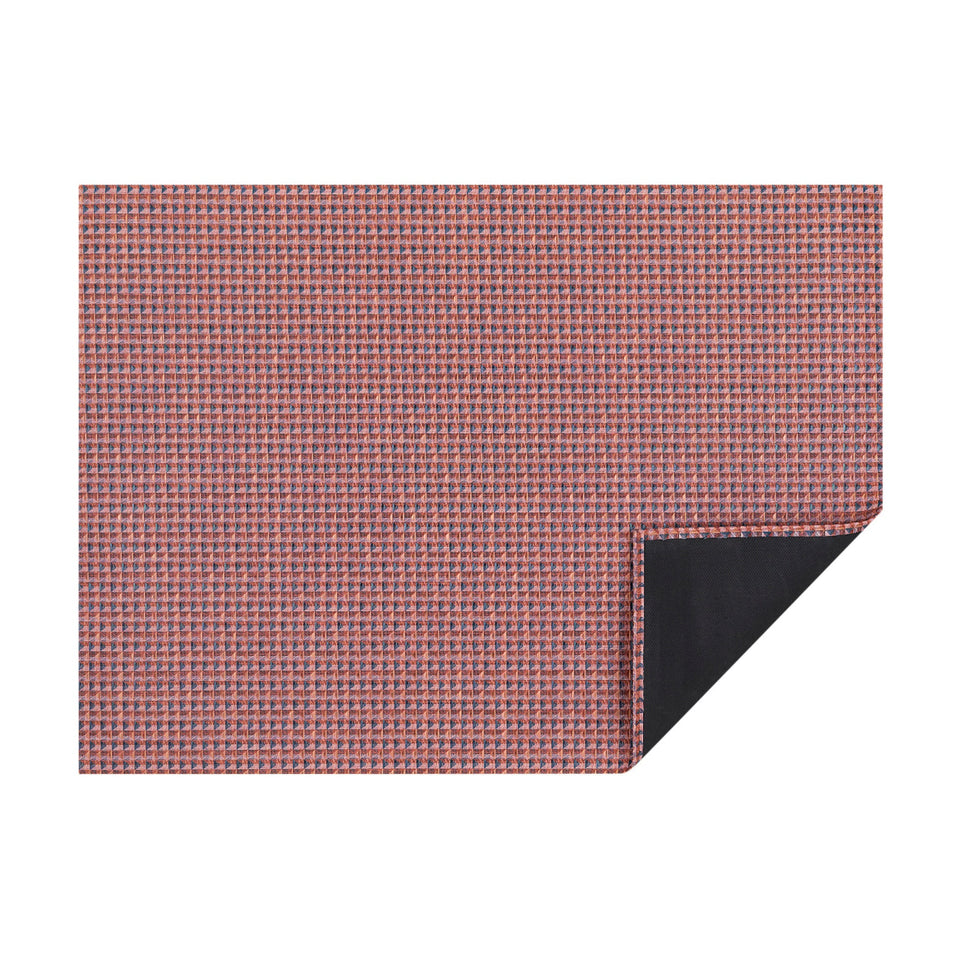 Raspberry Crane woven floor mat by Chilewich, horizontal folded-corner view
