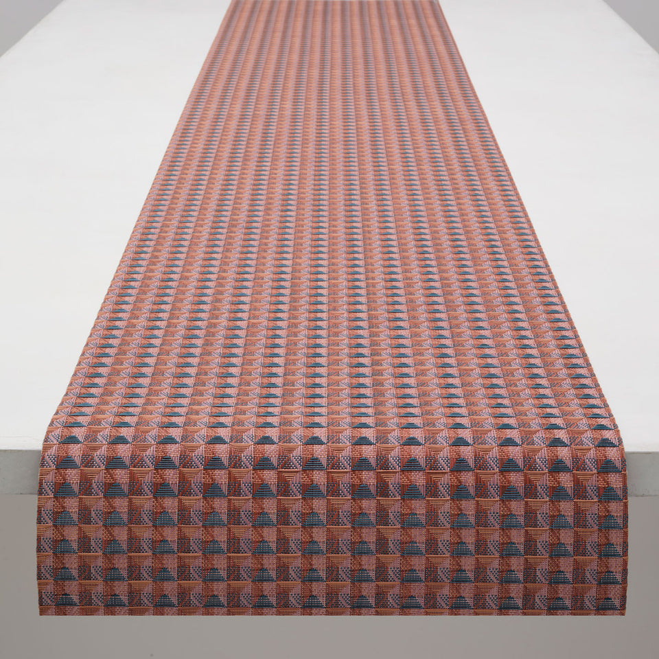 Chilewich Crane runner in Raspberry, draped along a table