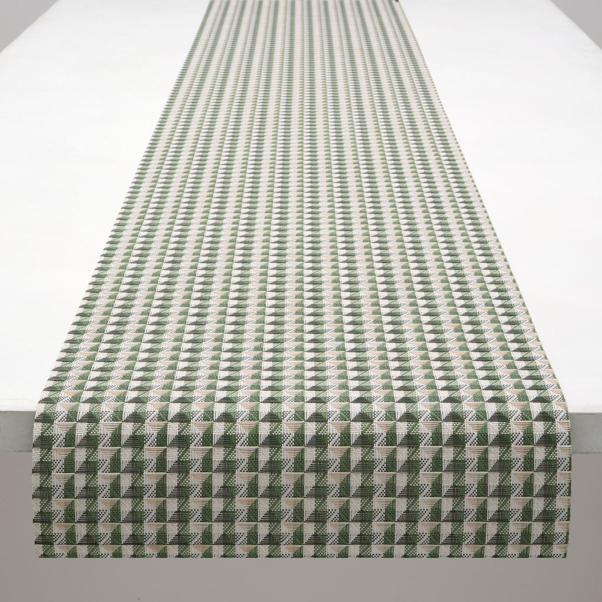 Chilewich Crane runner in Thyme, draped along a table