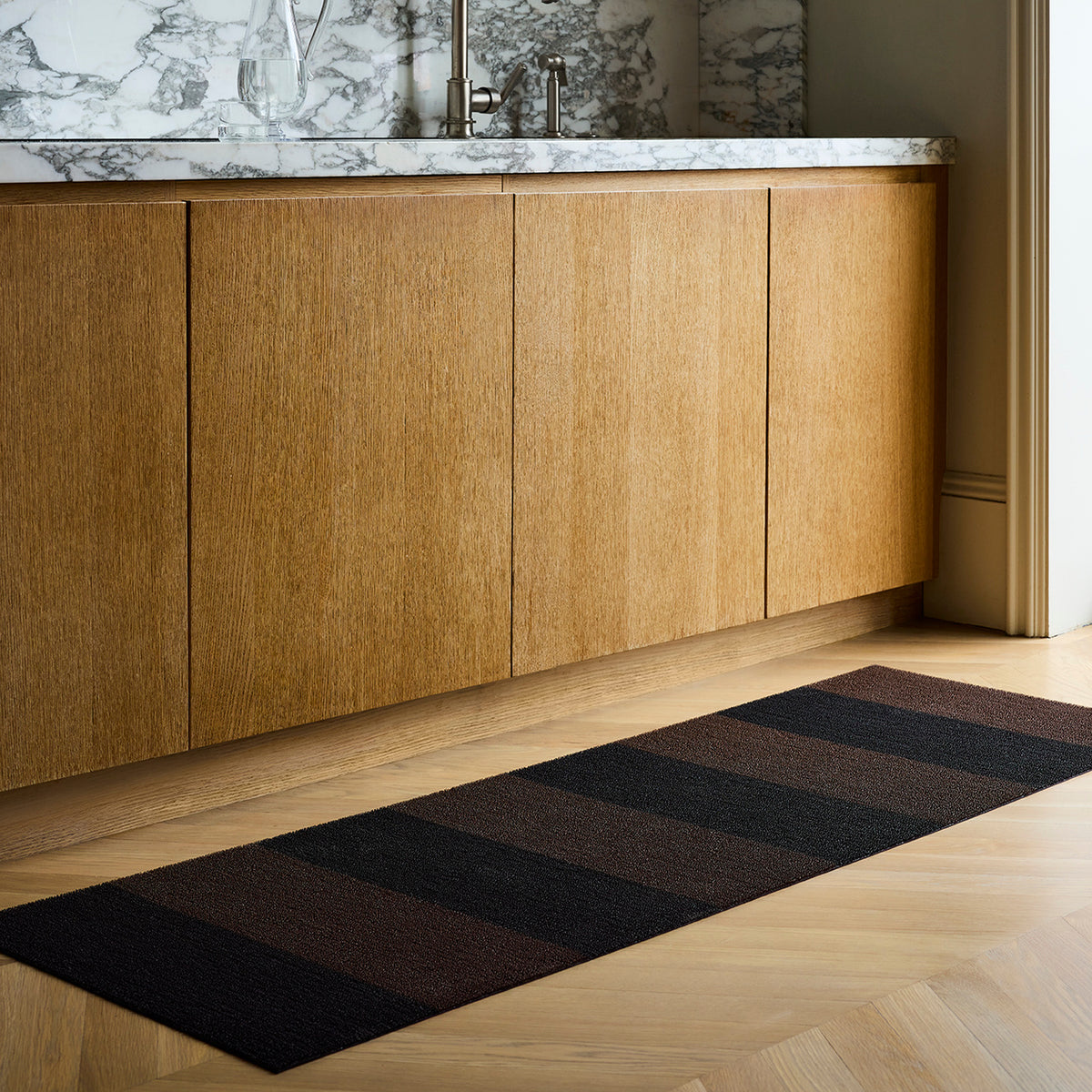 Mocha Duo Stripe Shag Mat by Chilewich — in an indoor setting