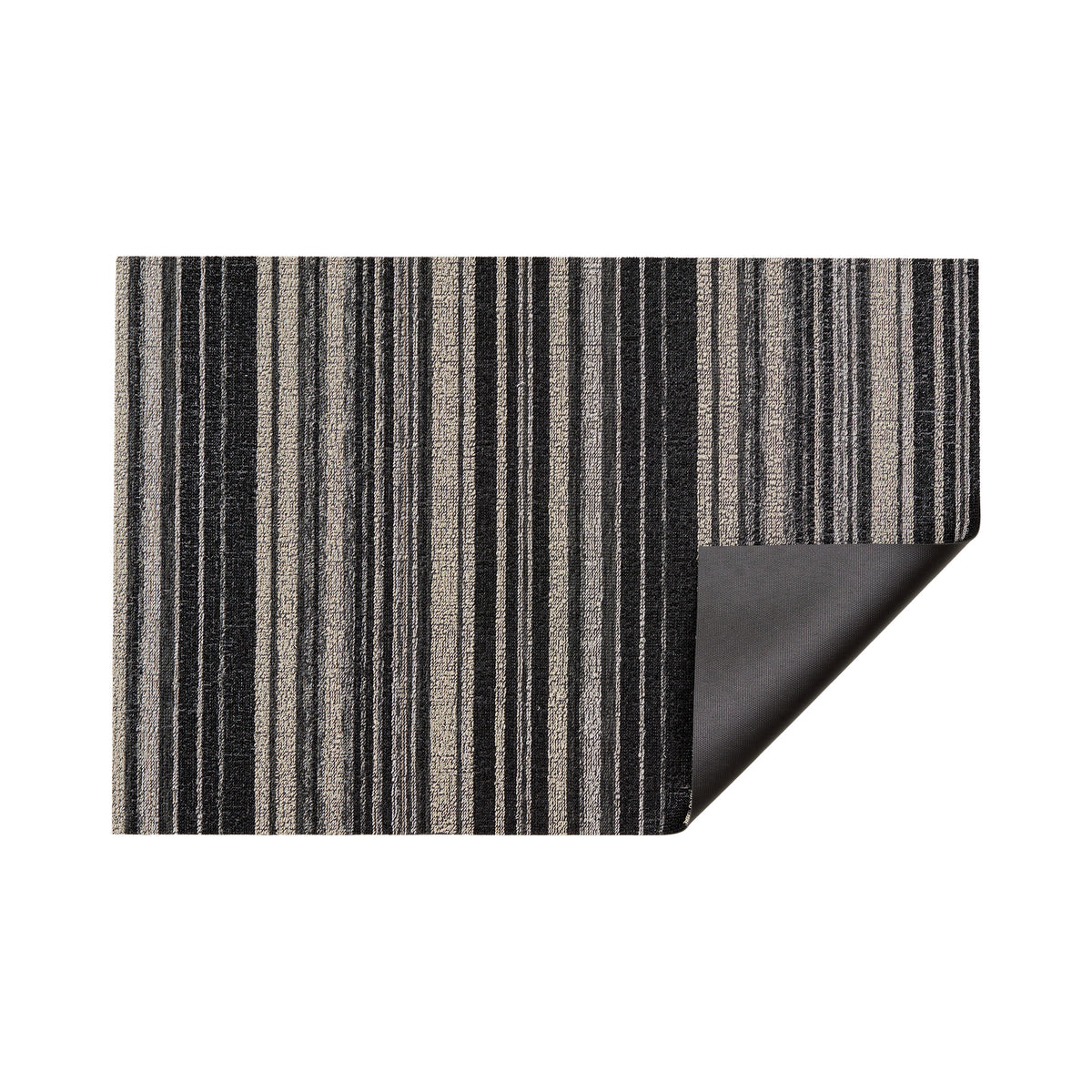 Shadow Echo Stripe Shag Mat by Chilewich — folded corner showing the vinyl backing