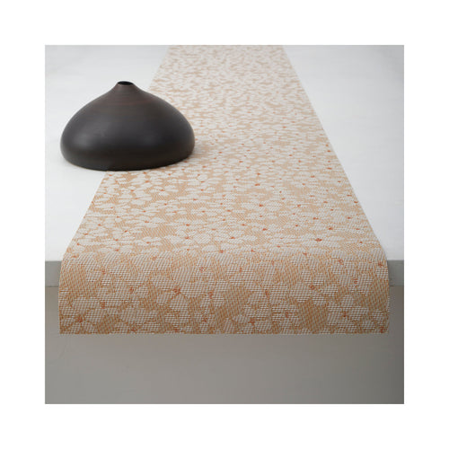 Chilewich Flora table runner in Almond, draped across a table