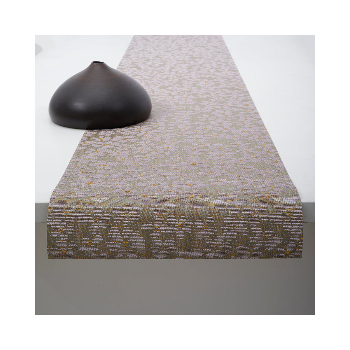 Chilewich Flora table runner in Mica, draped across a table