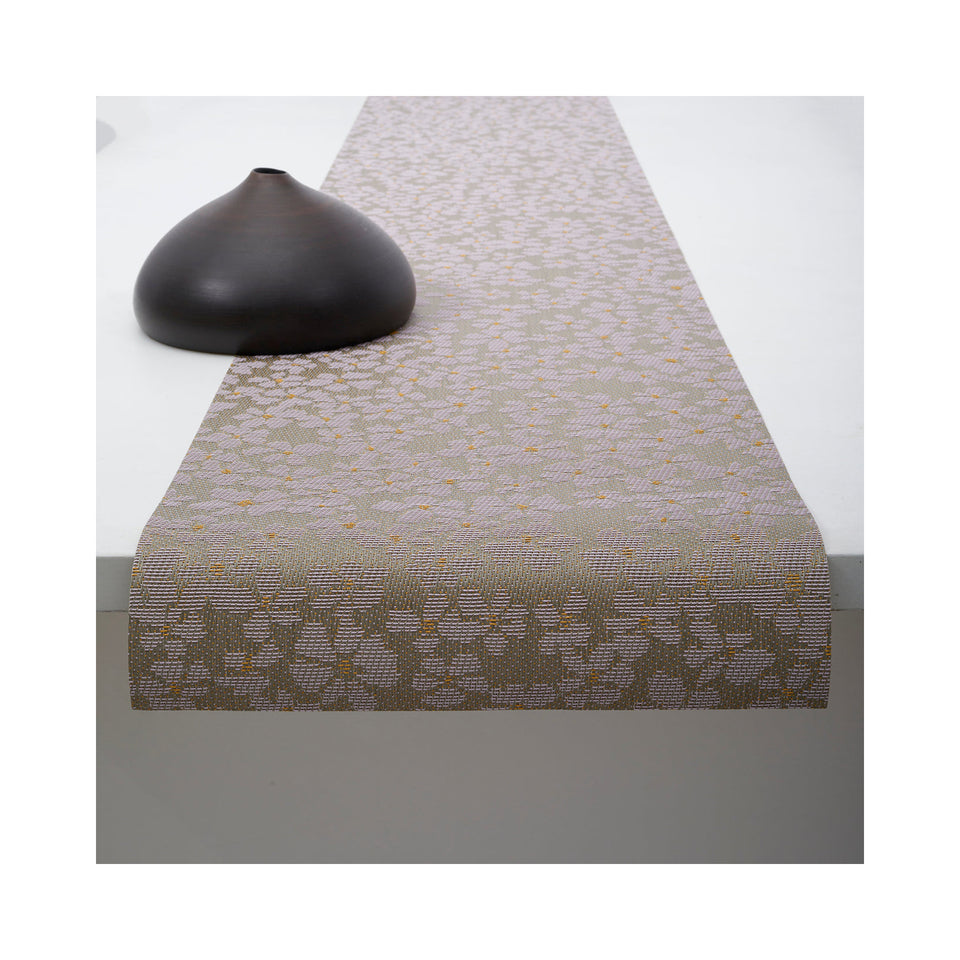 Chilewich Flora table runner in Mica, draped across a table