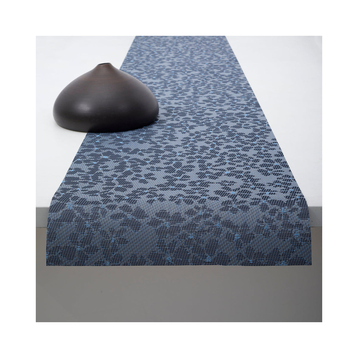 Chilewich Flora table runner in Zephyr, draped across a table