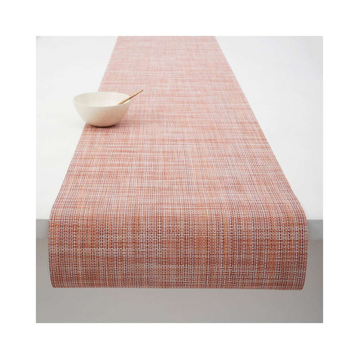 Chilewich Mini Basketweave table runner in Cinnamon, draped across a table