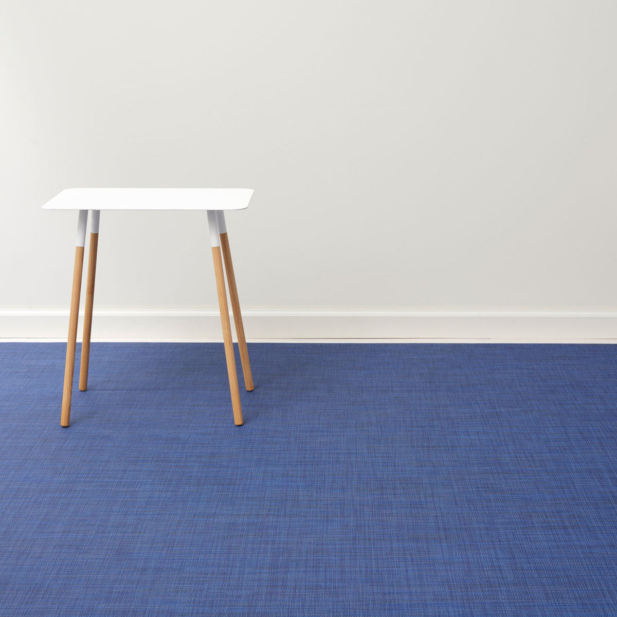 Mini Basketweave / Indigo woven floor mat by Chilewich, interior setting