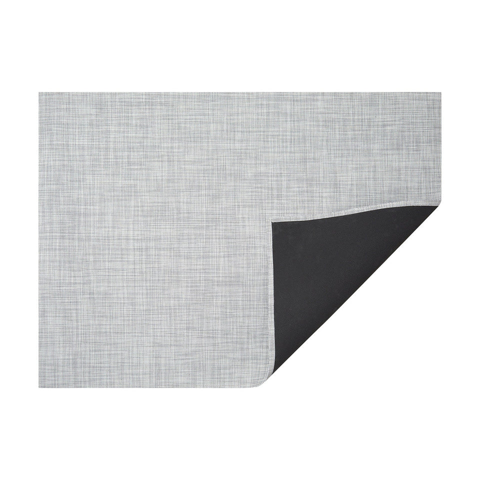 Mist Mini Basketweave woven floor mat by Chilewich, horizontal folded-corner view