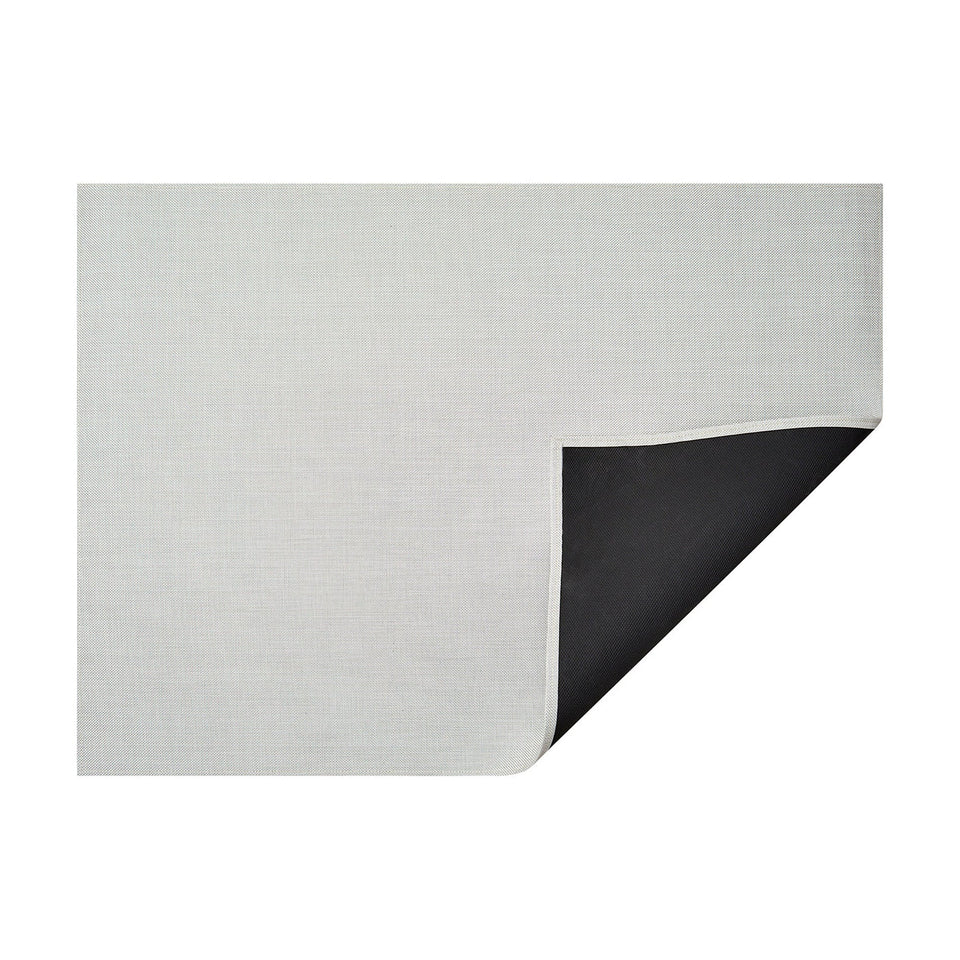 White Mini Basketweave woven floor mat by Chilewich, horizontal folded-corner view