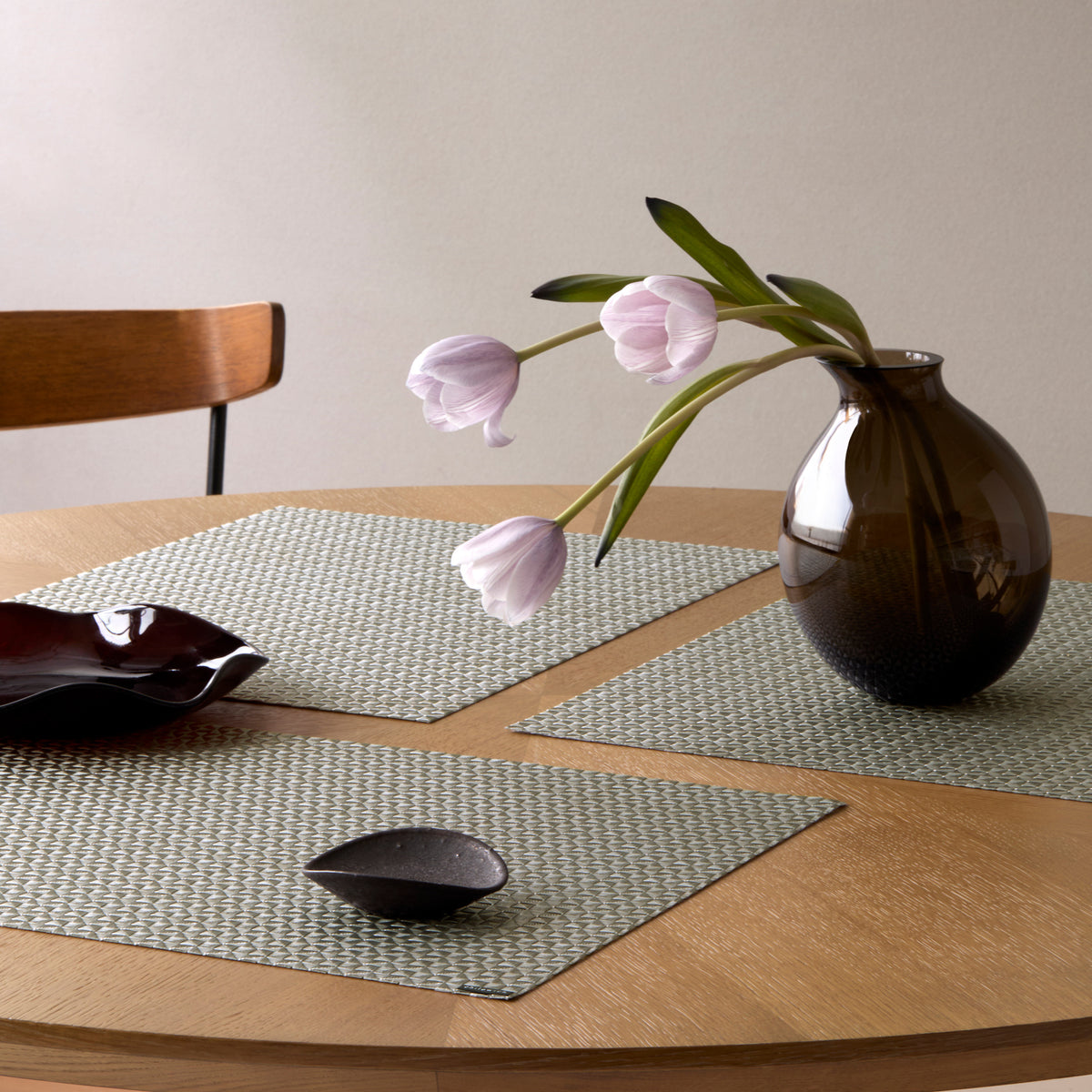 Chilewich Origami in Gunmetal, shown in a styled table setting
