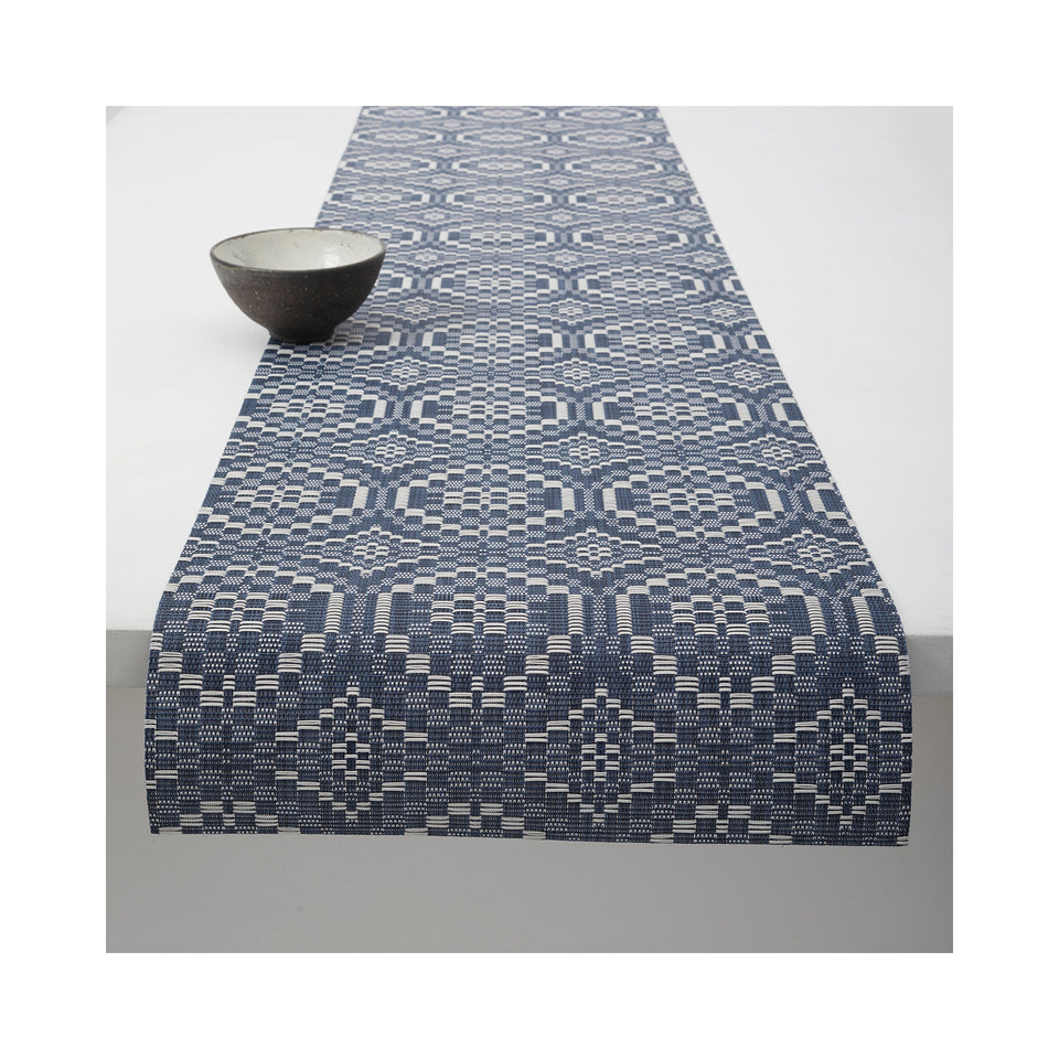 Chilewich Overshot table runner in Denim, draped across a table