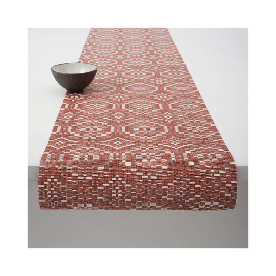 Chilewich Overshot table runner in Paprika, draped across a table