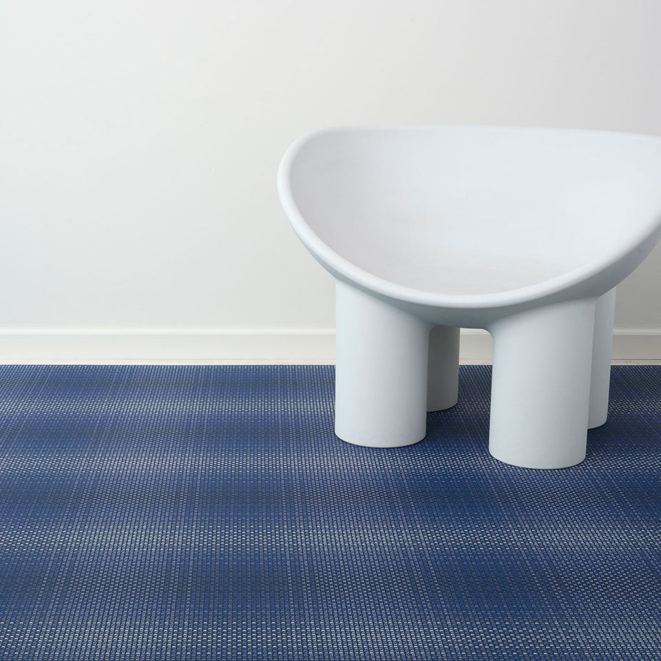 Parade / Ocean woven floor mat by Chilewich, interior setting