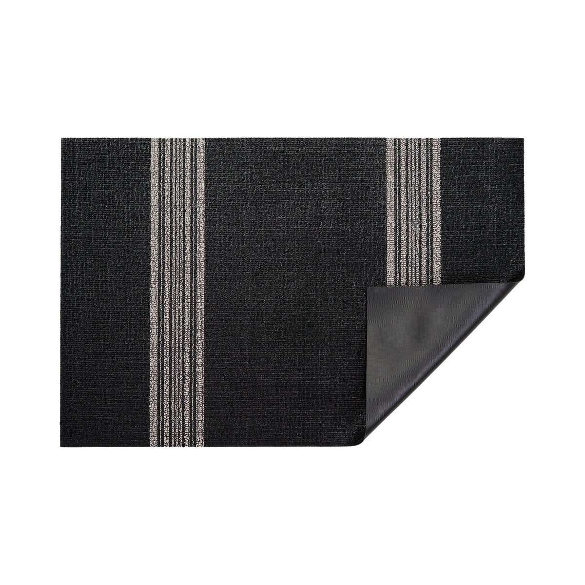Coal Relay Stripe Shag Mat by Chilewich — folded corner showing the vinyl backing