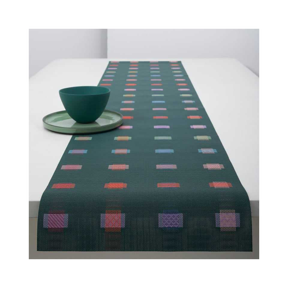 Chilewich Sampler table runner in Fir, draped across a table