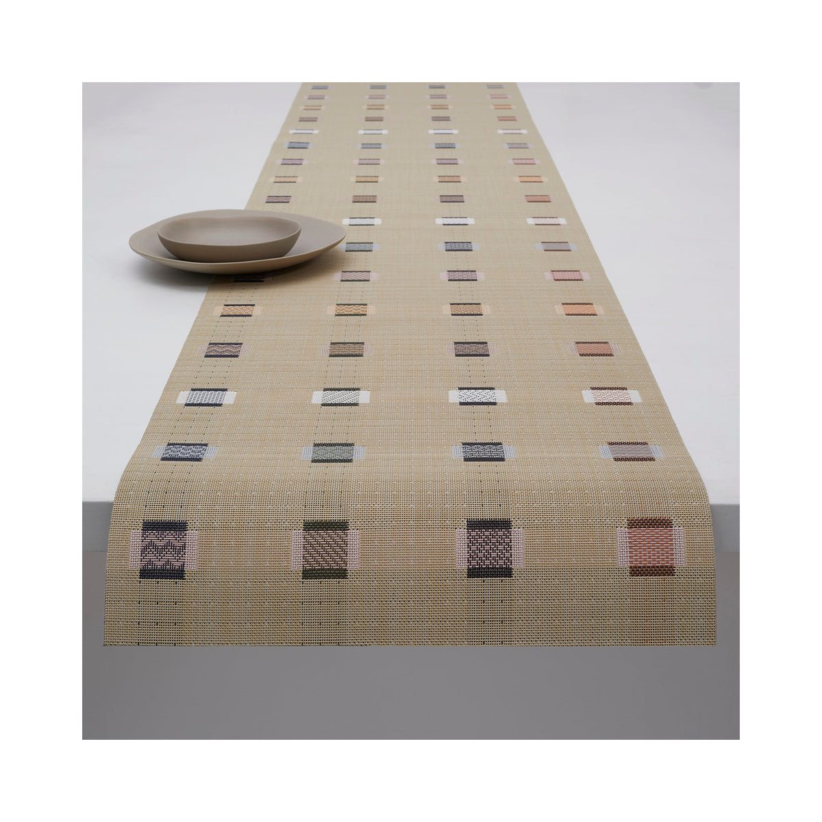 Chilewich Sampler table runner in Wheat, draped across a table