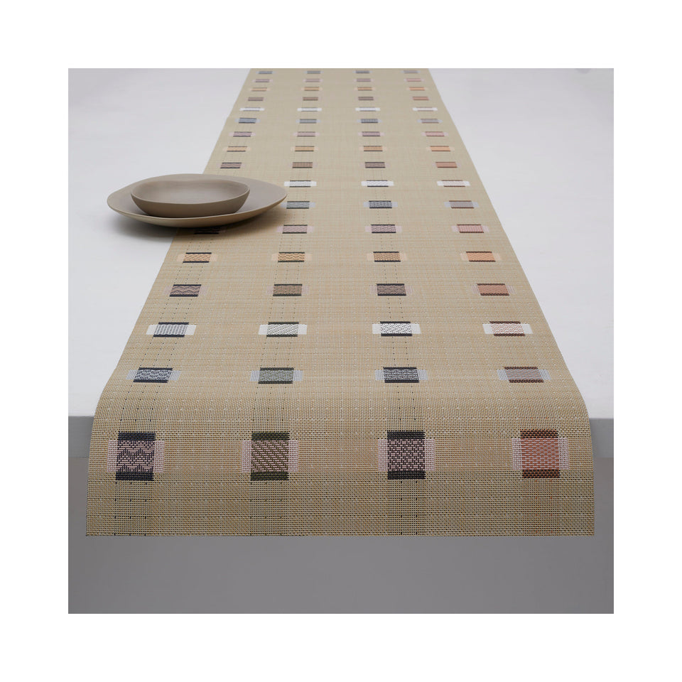 Chilewich Sampler table runner in Wheat, draped across a table