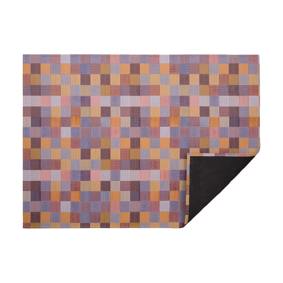 Opal Tint woven floor mat by Chilewich, horizontal folded-corner view
