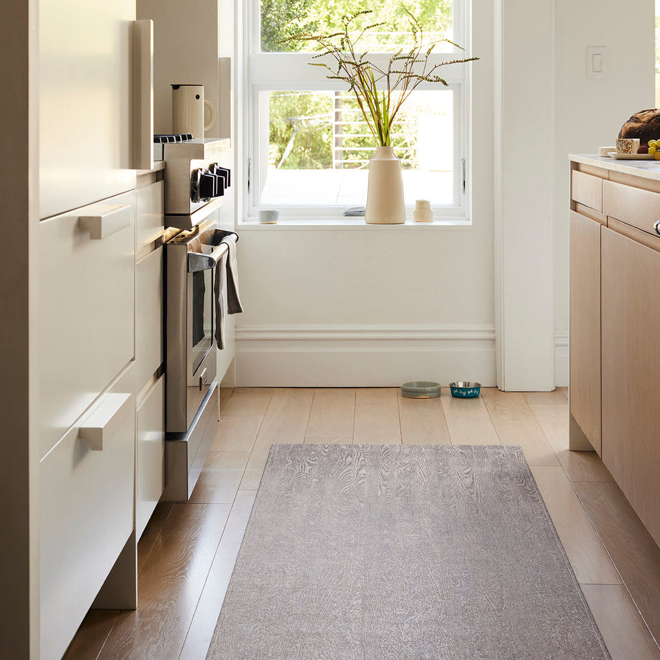 Woodgrain / Umber woven floor mat by Chilewich, interior setting