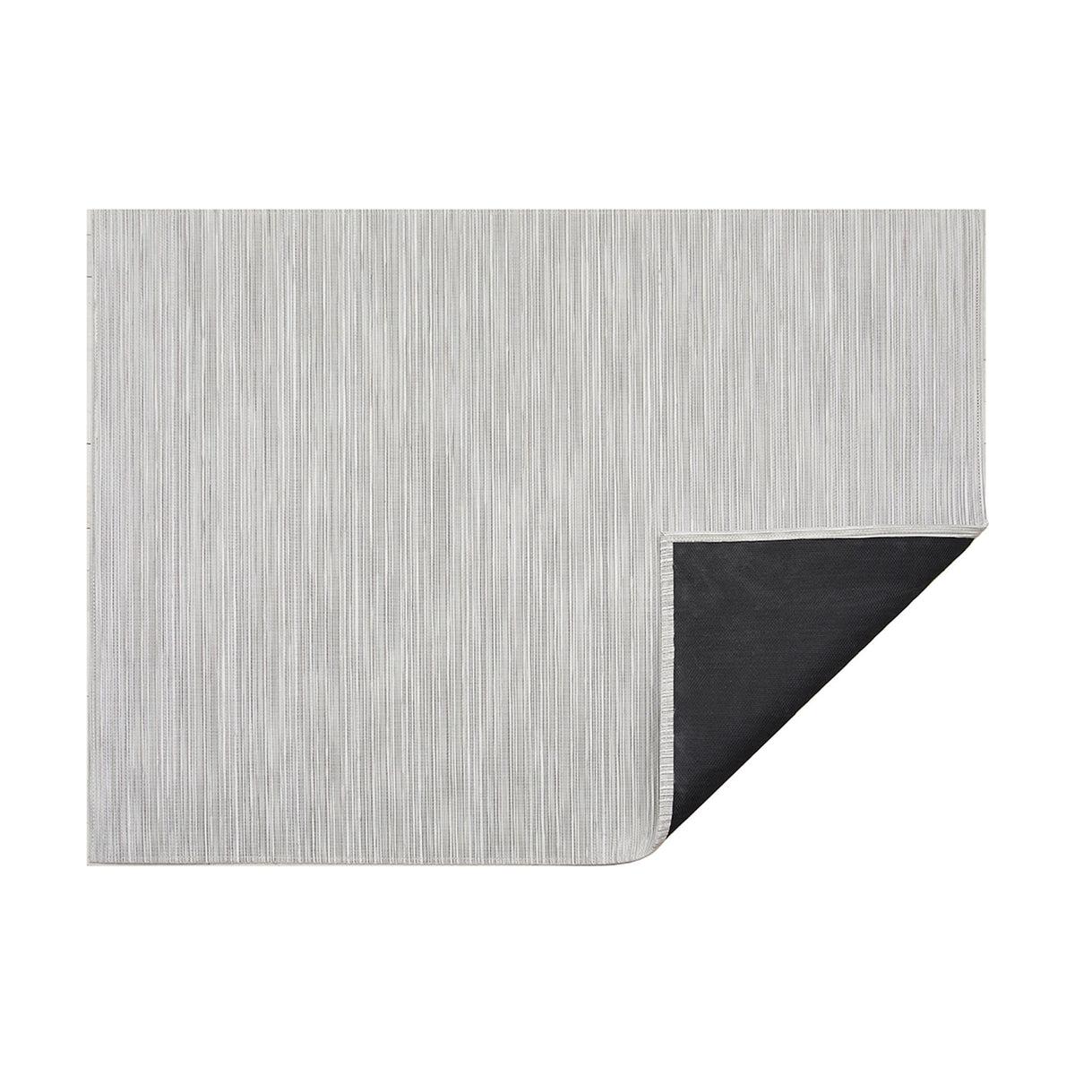 Rib Weave / Birch woven floor mat by Chilewich, folded-corner studio view