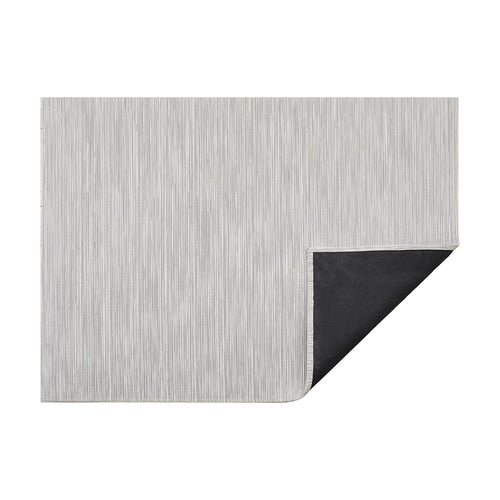 Rib Weave / Birch woven floor mat by Chilewich, folded-corner studio view