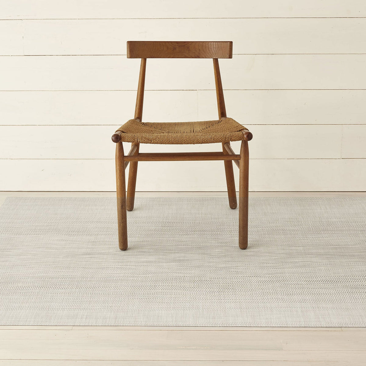 Wave / Grey woven floor mat by Chilewich, interior setting