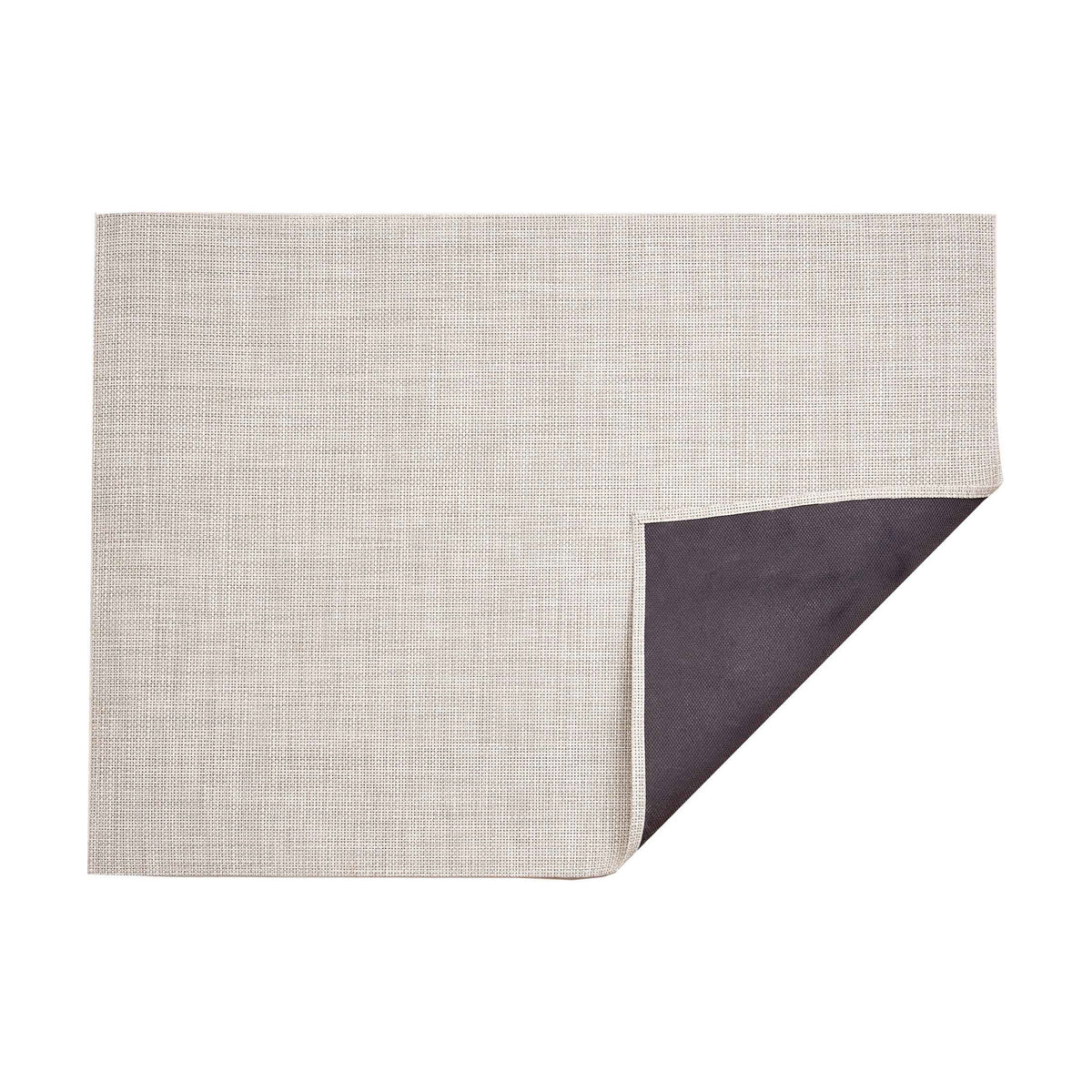 Basketweave / Natural woven floor mat by Chilewich, folded-corner studio view