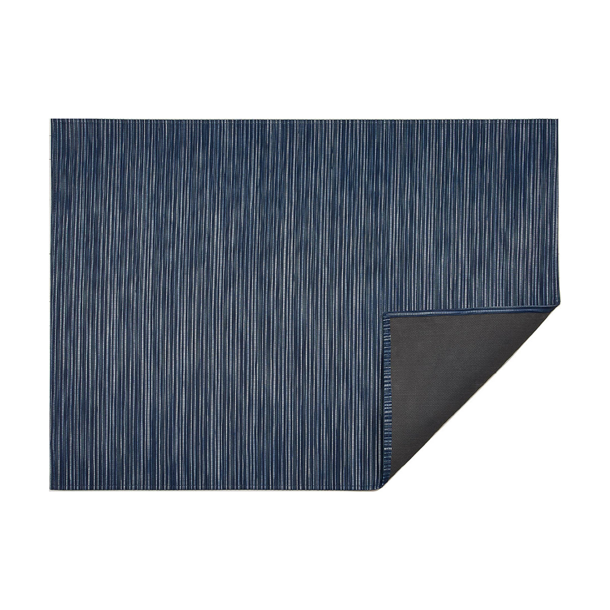 Rib Weave / Indigo woven floor mat by Chilewich, folded-corner studio view